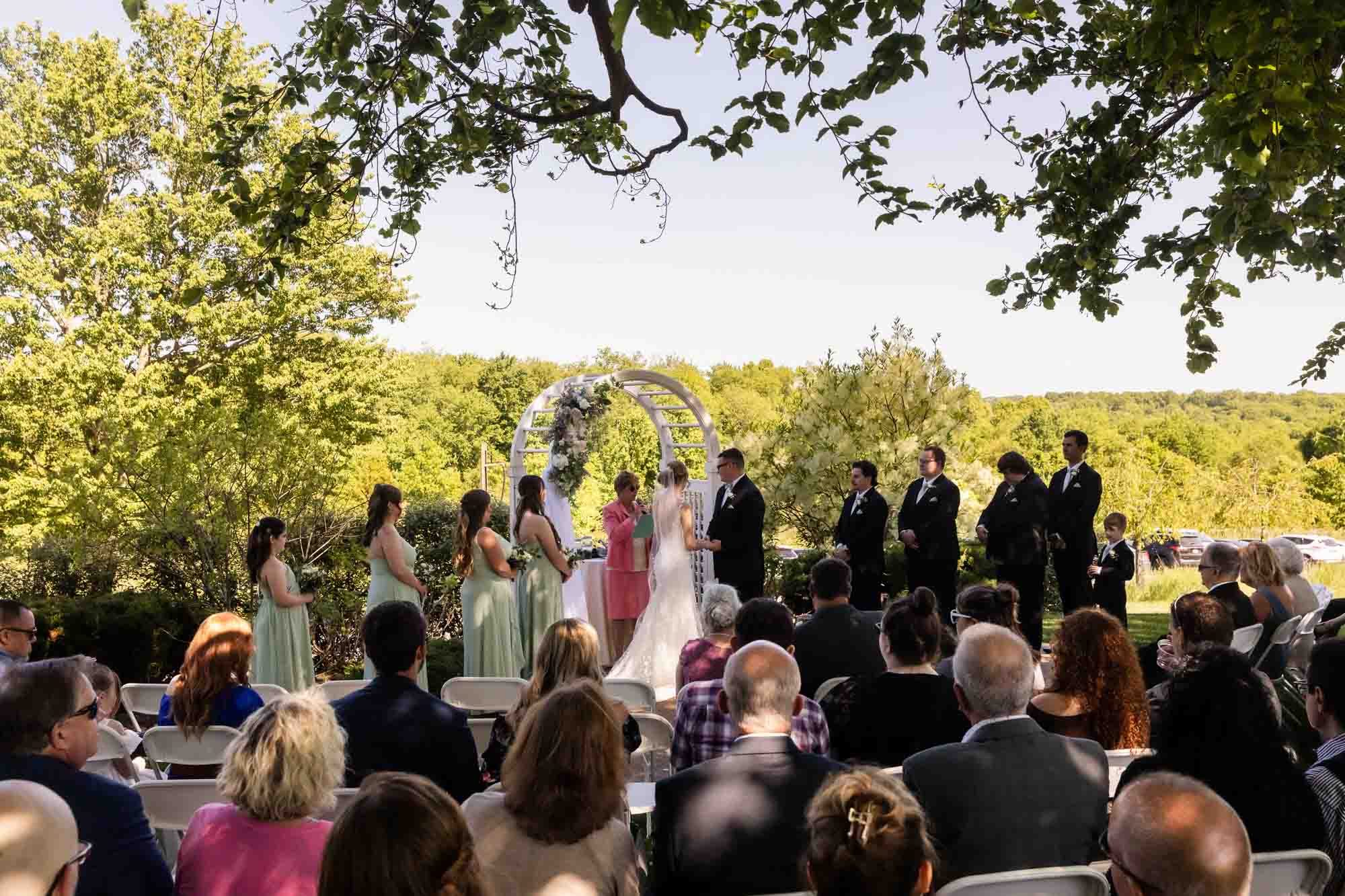 the ceremony location at pinehall at eisler farms is surrounded by shade trees
